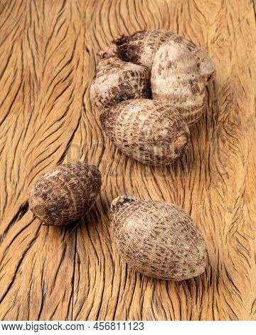 A Group Of Raw Yams Or Inhames Over Wooden Table.