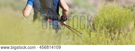 Trail Running Athlete Exercising For Fitness And Health Outdoors On Mountain Pathway