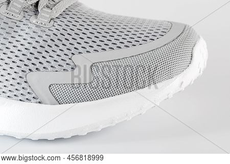 New Unbranded Running Sneaker Or Trainer On White Background. Men's Light Grai Sport Footwear. Close