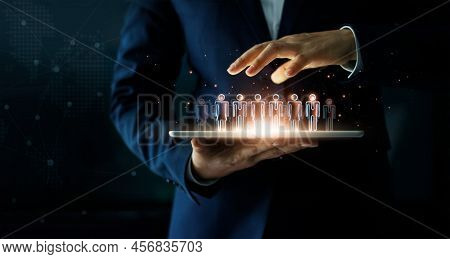 Businessman Holding Tablet And Management Group Of People In His Hand. Virtual Icon Of Social Networ