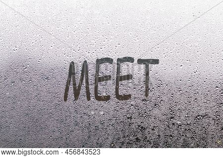 Foggy Glass On Window With Written Finger Word Meet