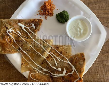 Aloo Paratha Or Indian Potato Stuffed Flatbread. Served With Fresh Curd And Chutneys. Selective Focu