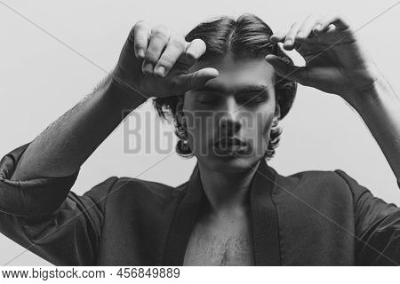 Portrait Of Young Handsome Man Posing In Black Jasket. Black And White Photography