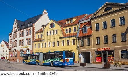 Eisleben, Germany - March 21, 2022: Blue Bus In Front Of Colorful Houses In Eisleben, Germany