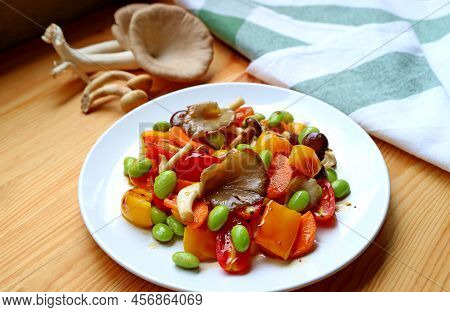 Delectable Colorful Grilled Vegetable Salad With Blurry Fresh Indian Oyster Mushrooms In The Backdro