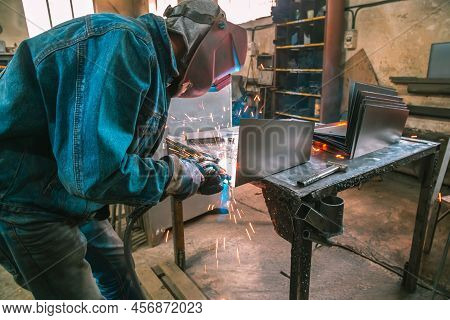 The Welder Works With Metal At The Factory