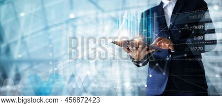 Businessman Using Tablet Analyzing Sales Data And Economic Growth Graph Chart.  Business Strategy. A