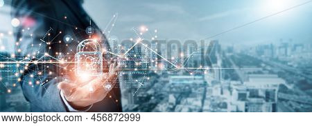 Cyber Security And Data Protection. Businessman Holding Padlock Protecting Business And Financial Da
