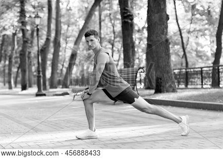 Warming Up Before Workout. Fit Guy Hold Lunge Position. Man Do Warm-up Exercises. Warm-up Activities