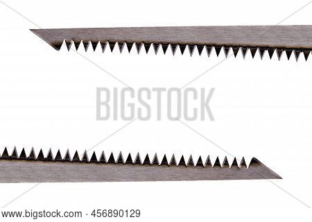 Two Straight Saw Blades Made Of Steel Above And One Below The Surface Pointing In Different Directio