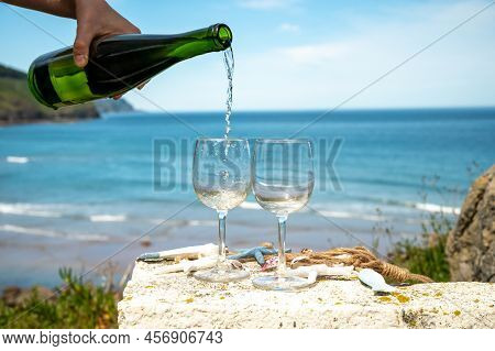 Pouring Of Txakoli Or Chacolí Slightly Sparkling Very Dry White Wine Produced In The Spanish Basque