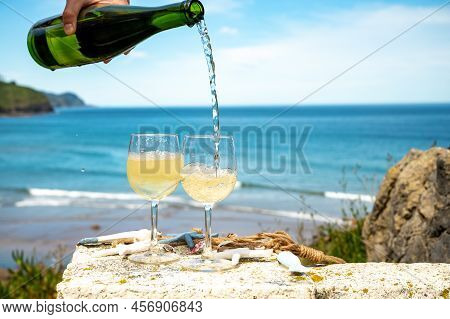 Pouring Of Txakoli Or Chacolí Slightly Sparkling Very Dry White Wine Produced In The Spanish Basque