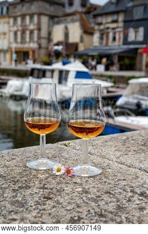 Tasting Of Apple Calvados Drink In Old Honfleur Harbour With Boats And Old Houses On Background, Nor