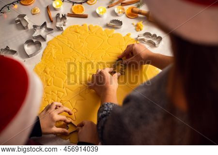 Mom And Son Are Preparing Homemade Cookies, Close-up Backshot. Dough And Cookies' Forms On The Table