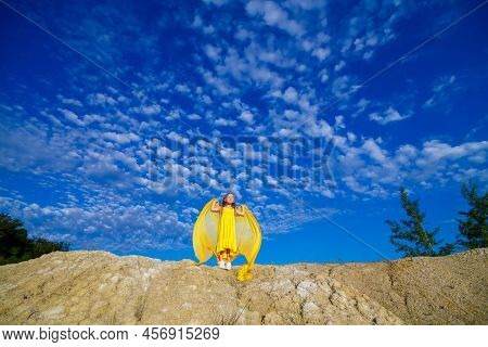 Ukrainian Patriot Girl In A Yellow Dress Against A Blue Sky. Summer Photo. Blue Sky. Sunny Day. Free