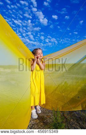 Ukrainian Patriot Girl In A Yellow Dress Against A Blue Sky. Summer Photo. Blue Sky. Sunny Day. Free