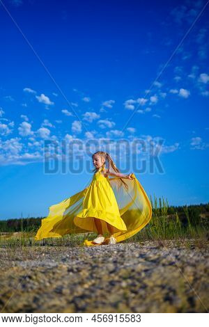 The Symbol Of Freedom Is A Ukrainian Girl Of 7 Years Old, Patriotically Dressed In A Yellow Dress Ag