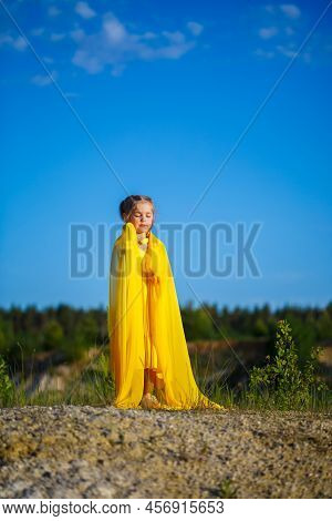 The Symbol Of Freedom Is A Ukrainian Girl Of 7 Years Old, Patriotically Dressed In A Yellow Dress Ag