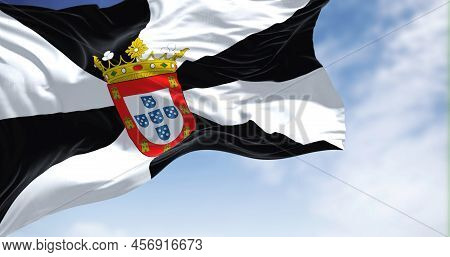 Rear View Of Ceuta City Flag Waving In The Wind On A Clear Day. Ceuta Is A Spanish Autonomous City O