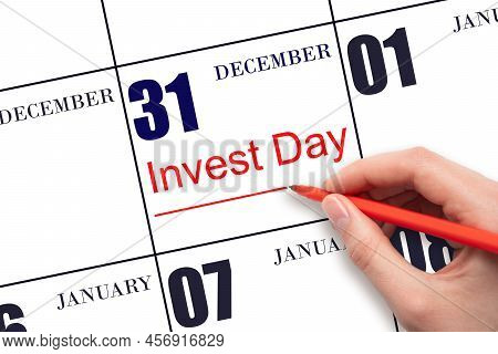 31st Day Of December. Hand Drawing Red Line And Writing The Text Invest Day On Calendar Date Decembe