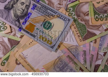 American One Hundred Dollars Banknote On Many Ukrainian Hryvnas