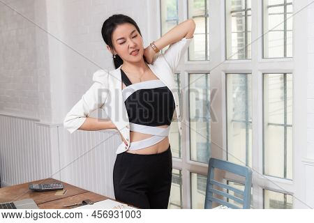 Office Syndrome Concept. Businesswoman Twisting The Body To Relieve Fatigue , Suffering From Pain Af