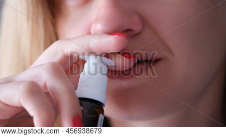 Woman Instilling Her Nose With Vasoconstrictor Drops Closeup. Acute Sinusitis Treatment Concept