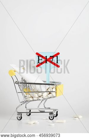Titanium Dioxide, E171, Dangerous Additive Concept. Gum, Pills, Toothpaste, Cream In Basket And Sign