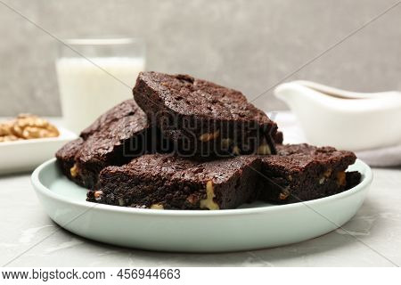 Delicious Chocolate Brownies With Nuts On Light Grey Table, Closeup