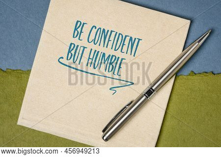 Be Confident But Humble Inspirational Note - Handwriting On A Napkin, Personal Development Concept