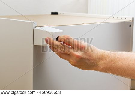 Professional Furniture Assembly Worker Assembles Shelf. Furniture Assembly Process. Diy Assembling