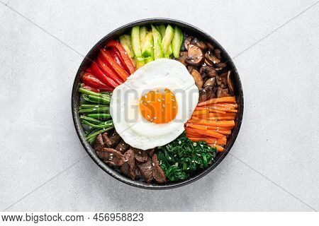 Bibimbap On A Concrete Background, Traditional Korean Dish, Top View