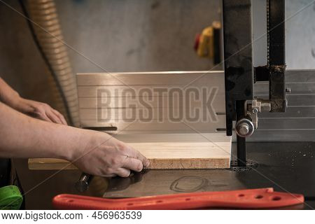Unrecognizable Joiner, Professional Man Hands Using Panel Sizing Saw Woodworking Machine To Cut Wood