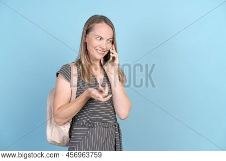 Middle Caucasian In Casual Clothes With Backpack And Mobile Phone Talking And Gesturing, Isolated On