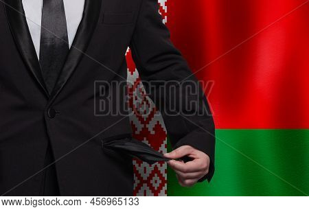 Belarusian Flag Background With Man Showing Empty Pockets. Financial Difficulties, Bad Economy, No M