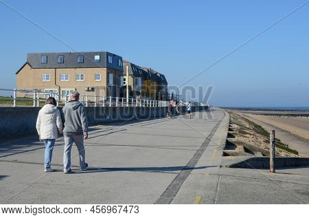 Prestatyn, Uk. Mar 27, 2022. A Couple Enjoy A Walk Along The Promenade At Barkby Beach On A Sunny Sp