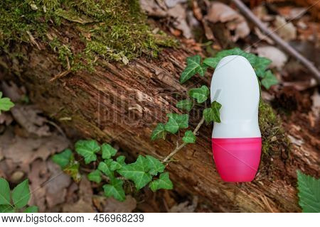 Bottle For Roll-on Deodorant Antiperspirant Laying On The Wood In The Forest, Beautiful Natural Back