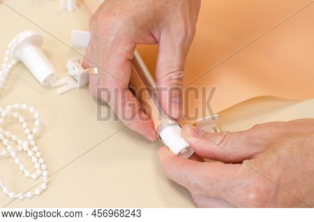 Male Hands Are Assembling Roller Blinds, Close-up. Assembly Of Roller Blinds