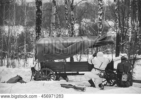 Hidden Re-enactor Dressed As German Wehrmacht Infantry Soldier In World War Ii Soldiers Sitting In A