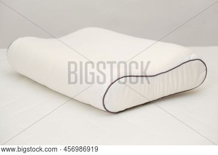 Orthopedic Pillow Made Of Memory Foam On A White Background. A Useful Right Pillow For Healthy Sleep