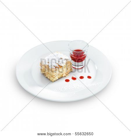 Delicious and yummy Napoleon cake with confectioners sugar and  berry topping on a round plate isolated on white