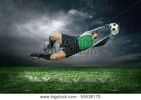 Football player with ball in action under rain outdoors