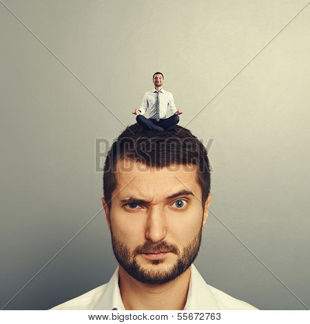 small happy man sitting on the head big dissatisfied man