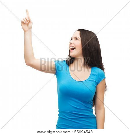 advertisement concept - attractive teenager in casual clothes pointing her finger up