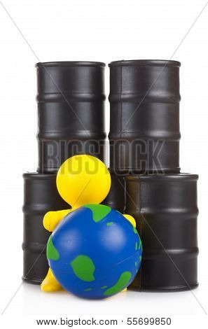 Toy  Little Man Sits Next On Butts To Oil The Globe. The World Supremacy Concept Oil-extracting The
