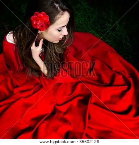 beautiful woman with red cloak  in the woods in spring