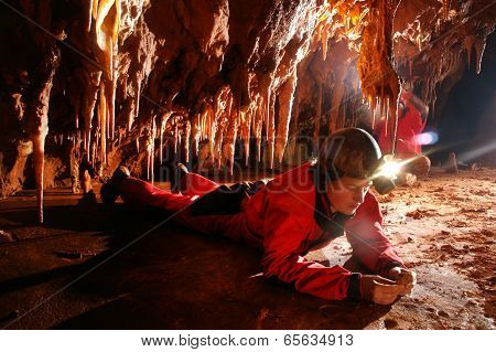 Paleontologist Studying Fossils In A Cave