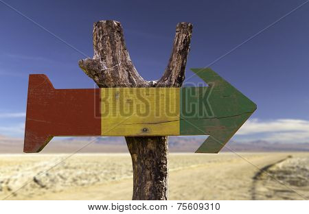 Guinea wooden sign with a desert background