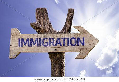 Immigration wooden sign on a beautiful day