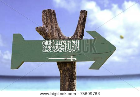 Saudi Arabia wooden sign with a river on background 